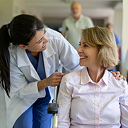 A female doctor smiling down at a patient