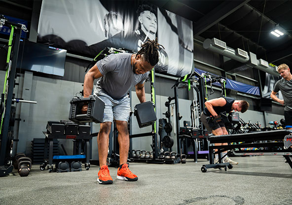 man lifting weights at gym