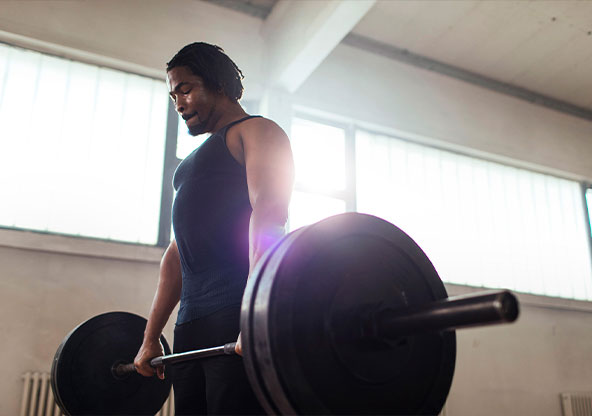 man lifting barbell